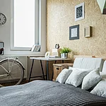 White city bicycle in bedroom with wooden wall