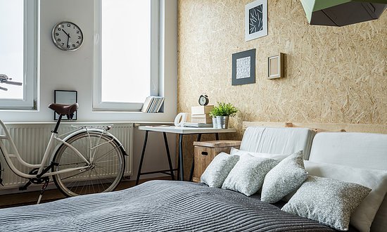 White city bicycle in bedroom with wooden wall